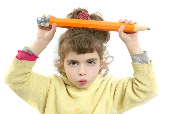 Küçük kız elindeki büyük kalem ile ciddi — Stok fotoğraf