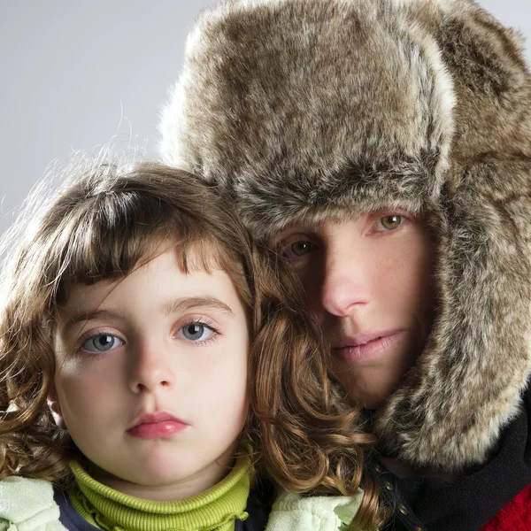 Mother and daughter winter portrait fur hat — Stock Photo, Image