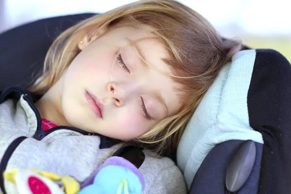 Little girl sleeping on children car safety seat — Stock Photo, Image