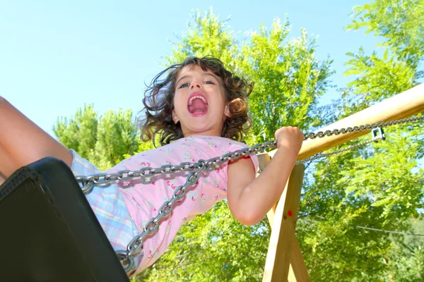 Girl swinging swing in outdoor park nature — Stock Photo, Image