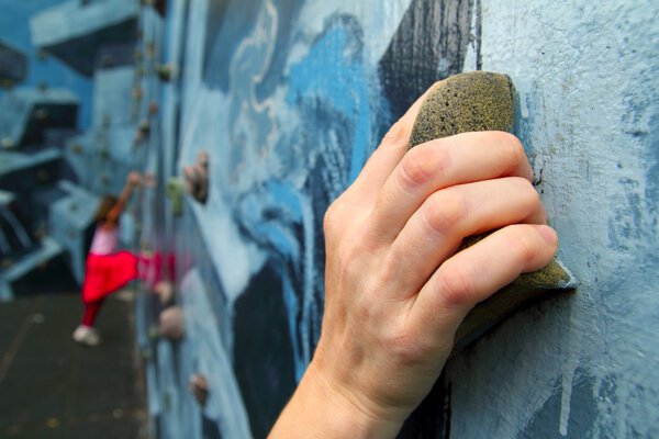 Climbing holds learning climbers in colorful wall