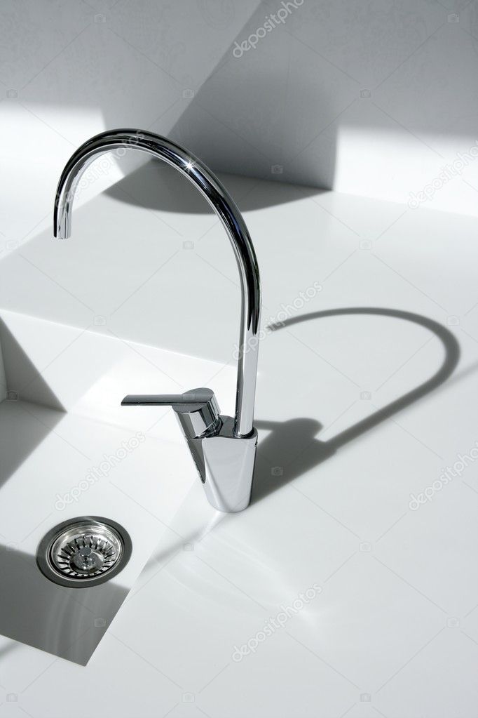White modern kitchen detail, faucet and sink