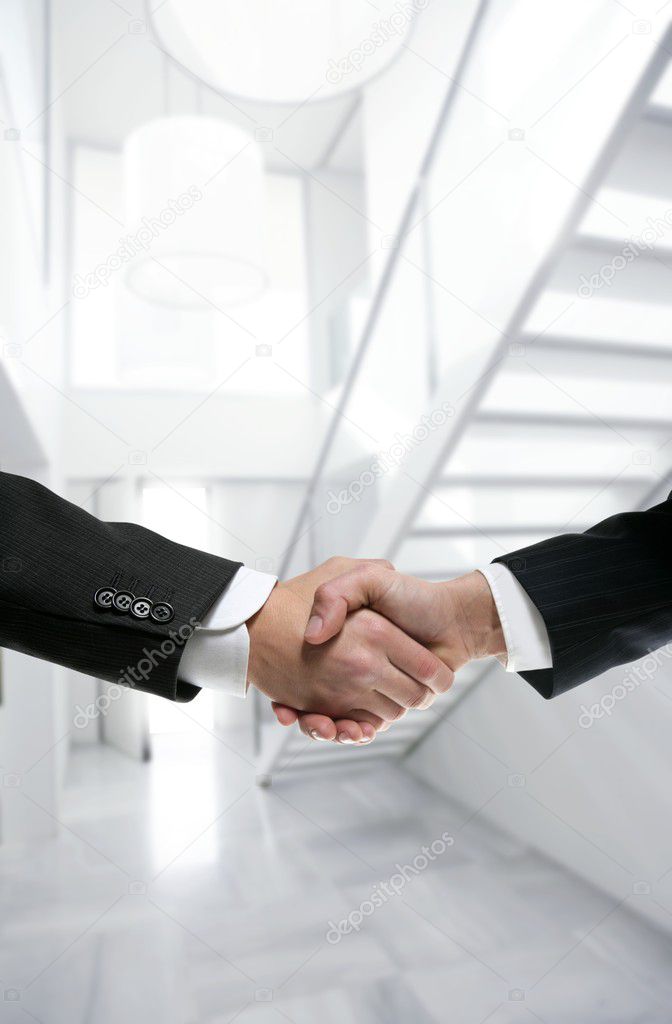 Businessman handshake on modern white office