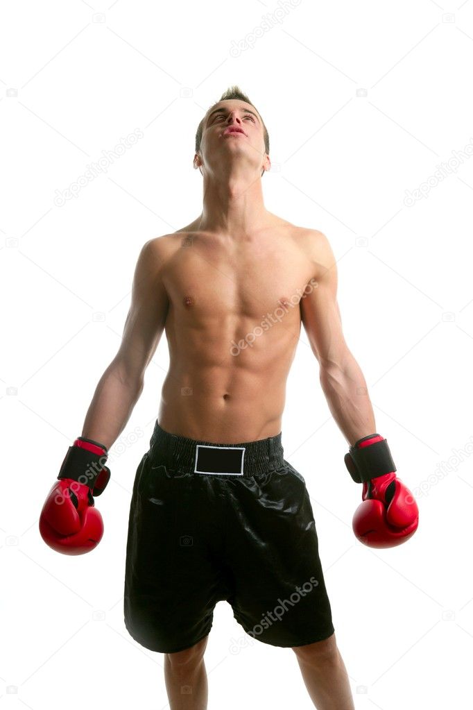 Young shaped man boxing in studio