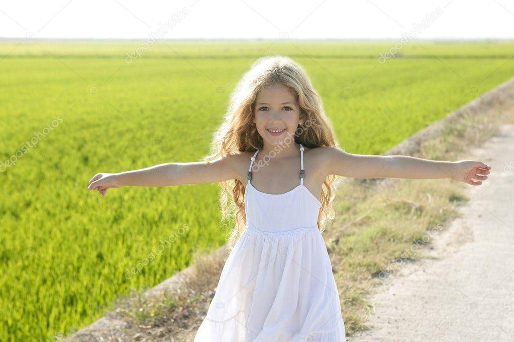 Open arms little happy girl meadow rice field track