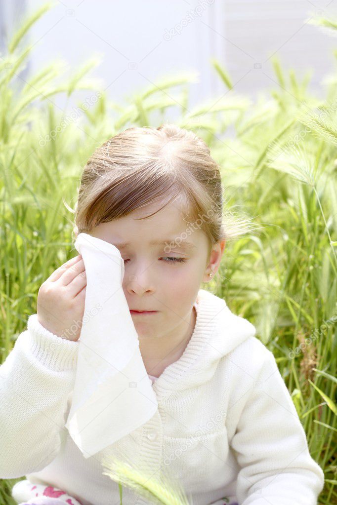 Sad little girl crying outdoor green meadow field