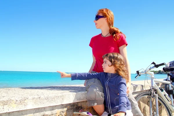 Daughter and mother on bicycle in beach — Stock Photo, Image