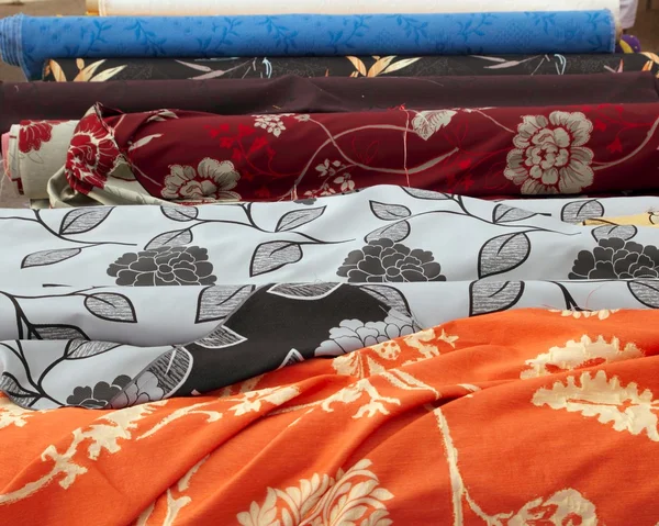 stock image Fashion fabric rolls in retail market shop in a row