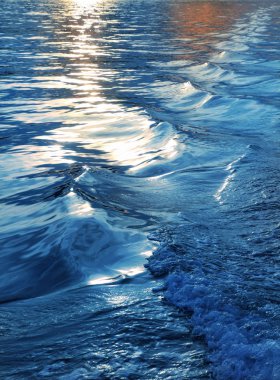 Blue sea water waves sunset from ship wake clipart