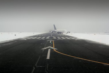 Airplane wing aircraft landing in snow winter runway clipart