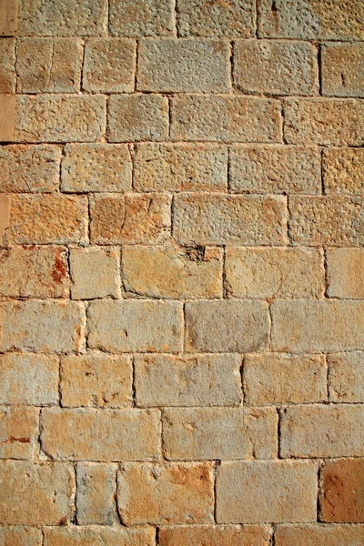 Castelo parede de alvenaria esculpida fileiras de pedra textura padrão — Fotografia de Stock