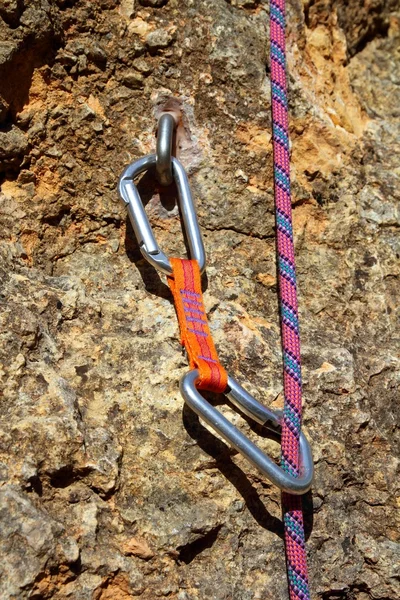 stock image Climbing shackles and rope on a rock wal