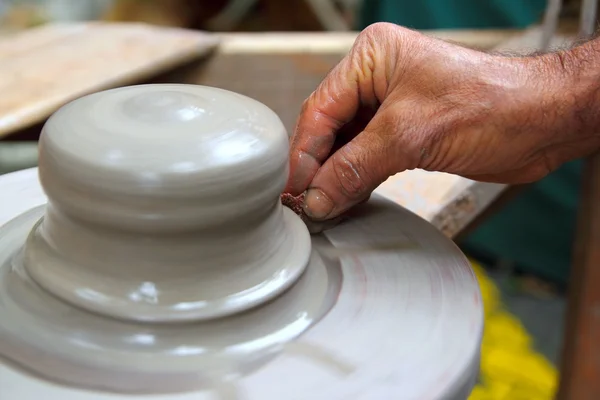 Man potter hands working on pottery clay wheel — Stock Photo, Image