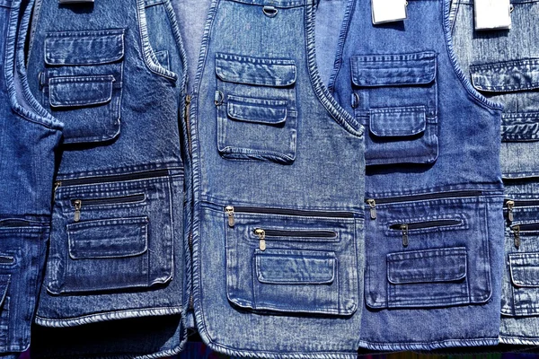 Denim blue jeans vest rows in a retail shop — Stock Photo, Image