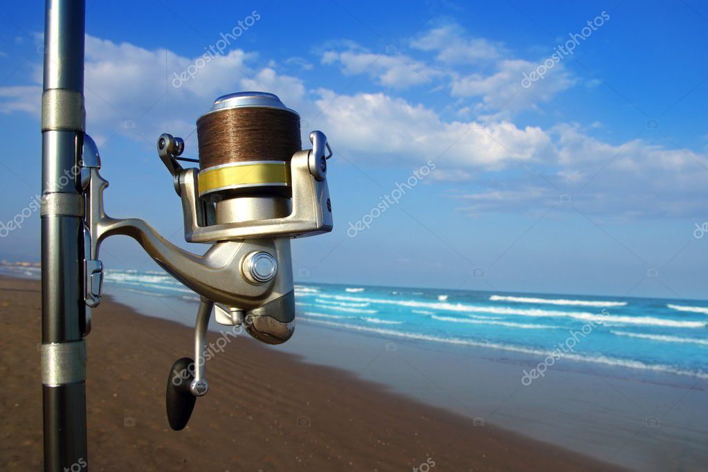 Beach surfcasting spinning fishing reel and rod Stock Photo by