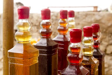 Colorful traditional liquor bottles in rows clipart