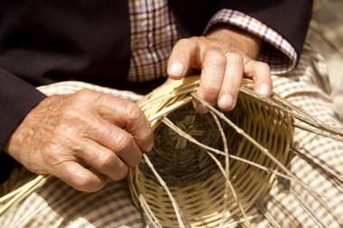 Basketry craftsman hands working in Mediterranean basket clipart