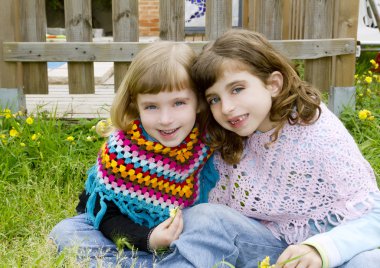 Children sister girls smiling in meadow spring fence clipart