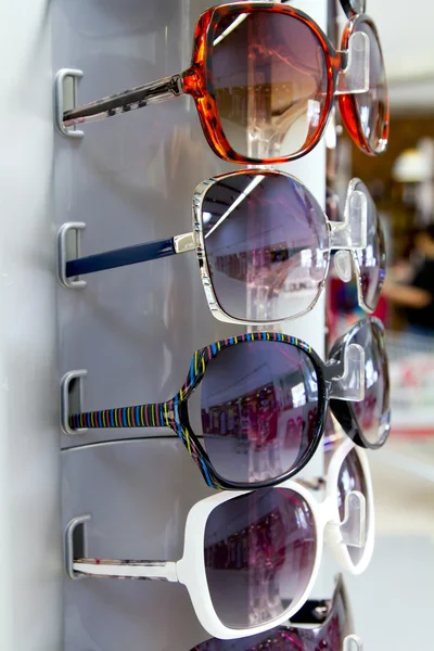 Sunglasses sun glasses stacked row in shop display — Stock Photo, Image