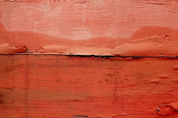 Leeftijd verweerde hout geschilderd in rood oranje kleur — Stockfoto