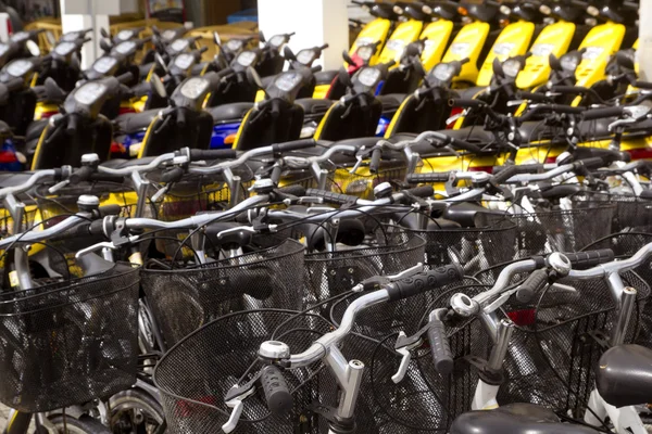 Bicycles and scooter bikes rows in a renting shop — Stock Photo, Image