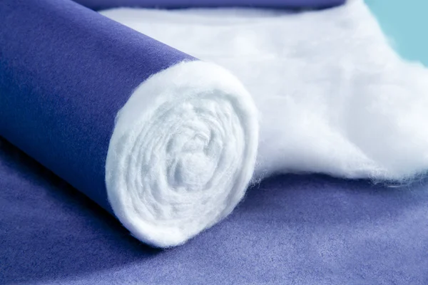 Blue rolled medical cotton pharmaceutical background — Stock Photo, Image