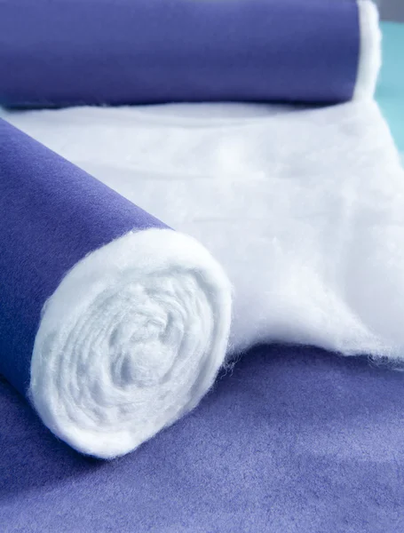 Blue rolled medical cotton pharmaceutical background — Stock Photo, Image