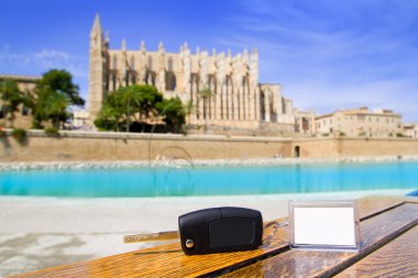 Car rental keys on wood table in Palma de Mallorca cathedral clipart