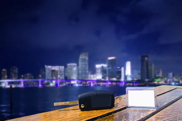 stock image Car rental keys on wood table in Miami night