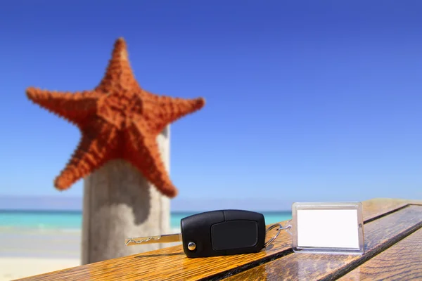 Mietwagen-Schlüssel auf Holztisch im Urlaub mit Seesternen — Stockfoto