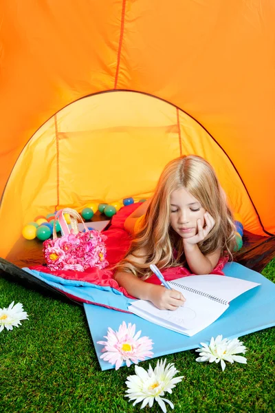 Children girl writing notebook in camping tent with flowers — Stock Photo, Image
