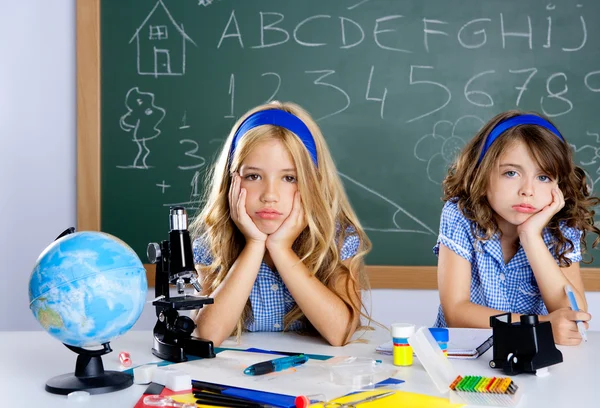 Bored student kids at school classroom in desk — Stock Photo, Image