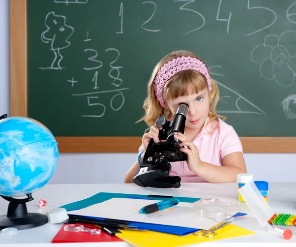 Children little girl at school classroom with microscope — Stock Photo, Image