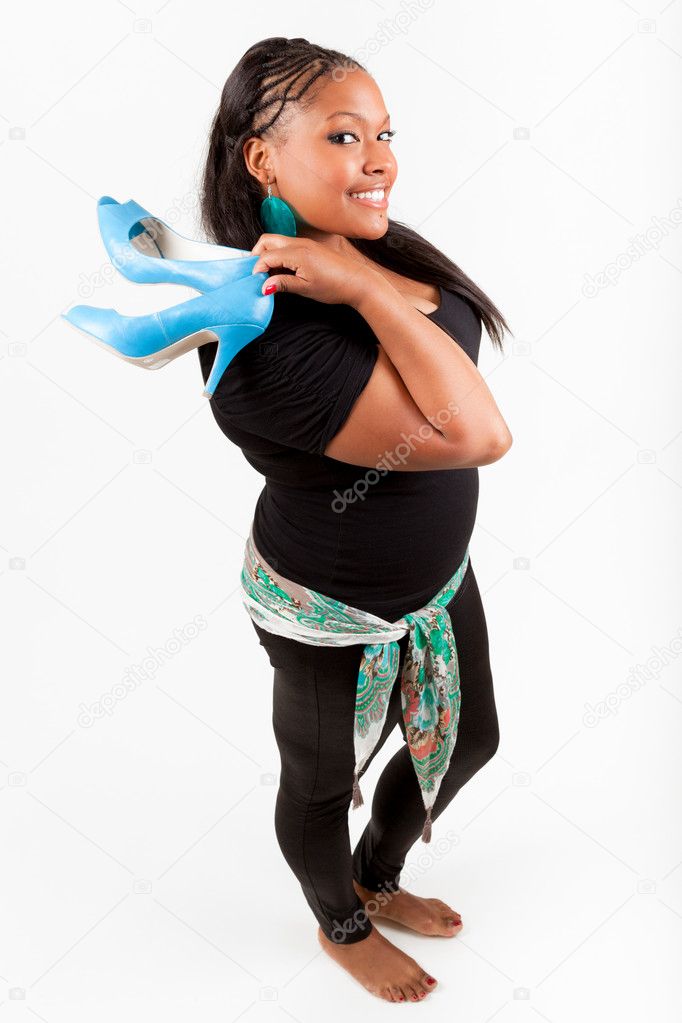 Beautiful African American woman holding a pair of shoes