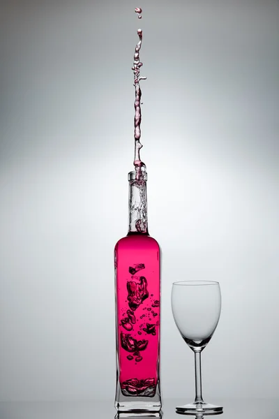 stock image Liquid splashing from a bottle