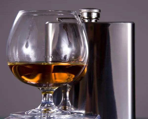 Glass with cognac and Flask — Stock Photo, Image