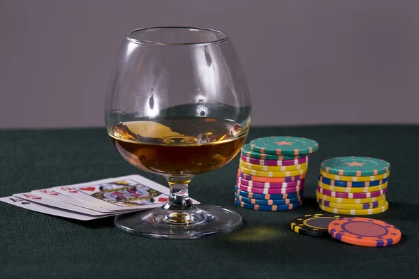 Glass with cognac and chips — Stok fotoğraf