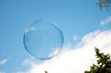 Soap bubble on the blue sky clipart