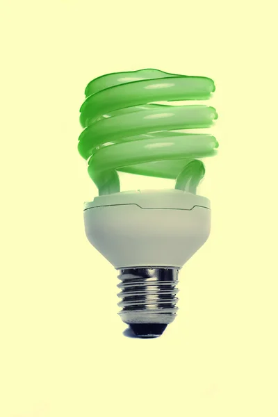 Light bulb standing on a yellow background — Stock Photo, Image