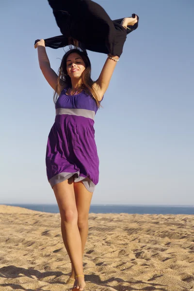 Playful beautiful young girl with purple dress — Stock Photo, Image