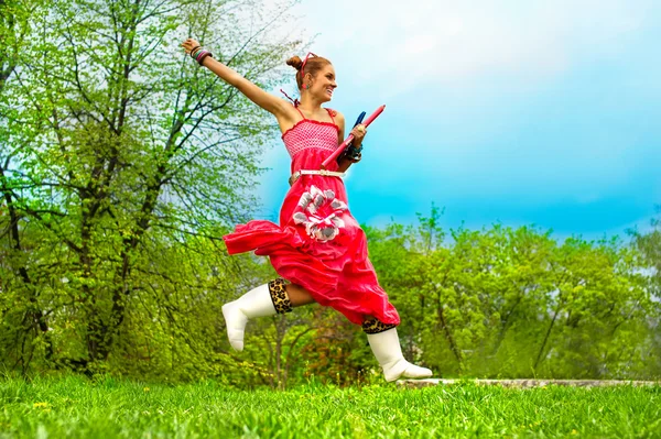 Jumping woman on green grass — Stock Photo, Image