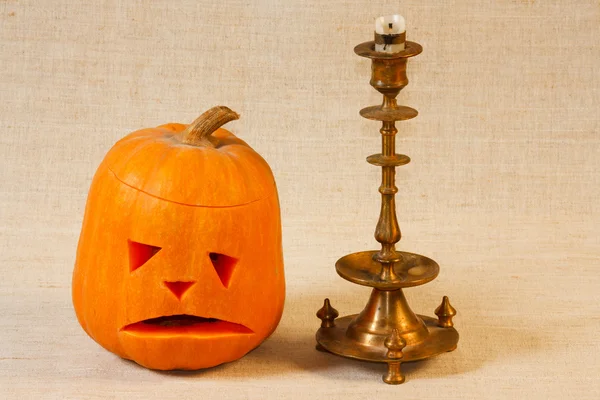 The sad and cheerful halloween pumpkin with candle — Stock Photo, Image