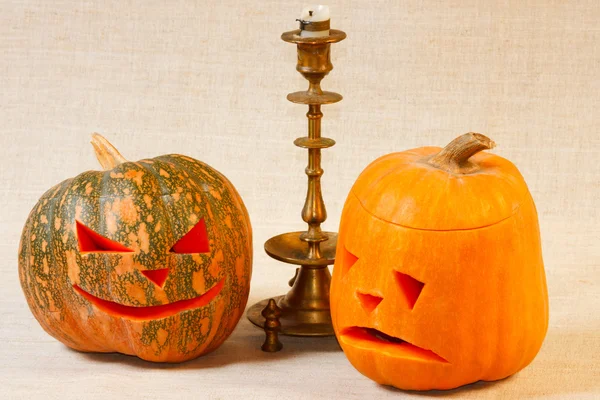 The sad and cheerful halloween pumpkin with candle — Stock Photo, Image