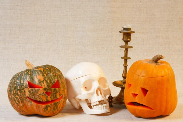 The cheerful and sad halloween pumpkin and skull — Stock Photo, Image