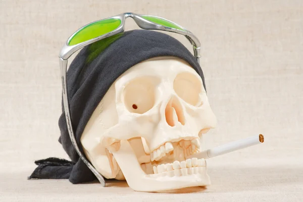 The skull with black bandana and cigarette — Stock Photo, Image