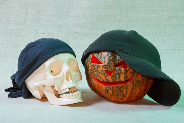 The big cheerful halloween pumpkin and skull Stock Picture