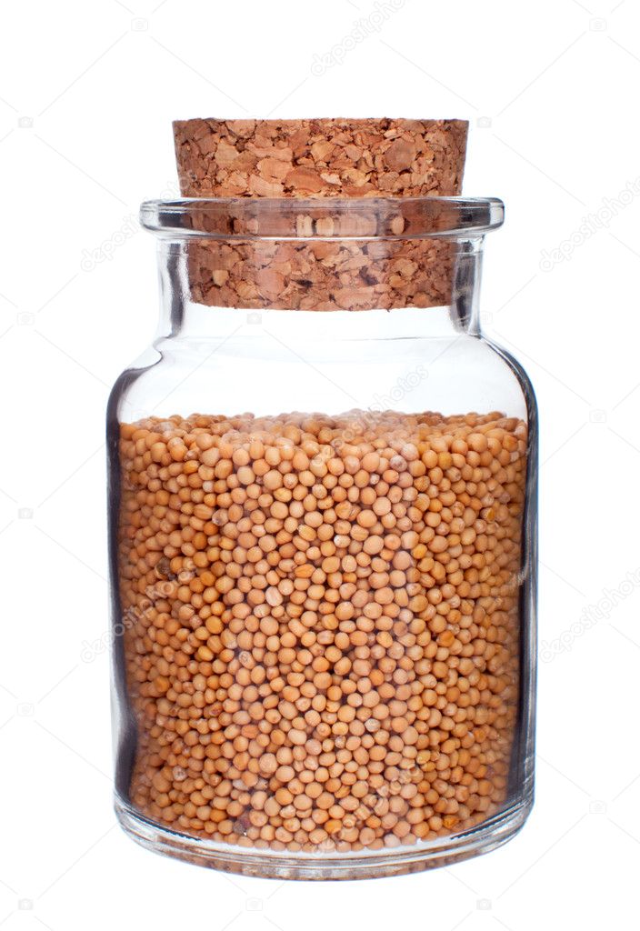 Glass bottle full of mustard seeds isolated on white — Stock Photo