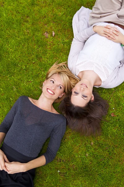 stock image Two girls lying in the grass