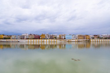 Sevillie, panorama of the peaceful riverside clipart