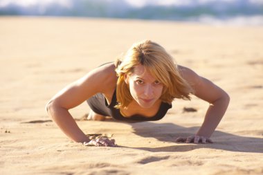 Young fit girl doing push ups clipart